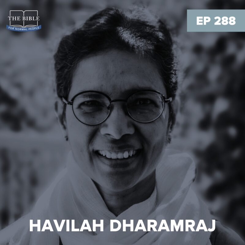 close up headshot of Havilah Dharamraj wearing a white scarf with foliage in the background